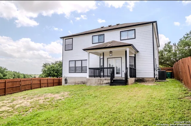 a view of a house with backyard and porch