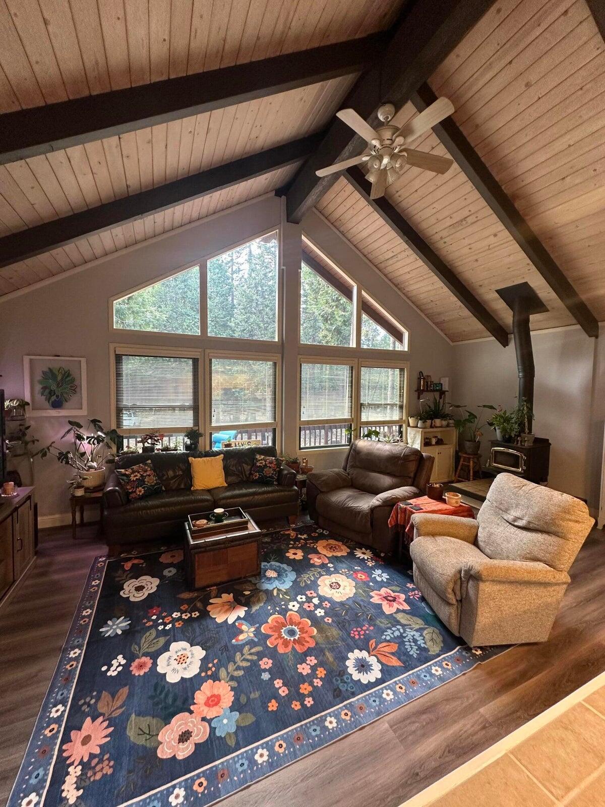 8308 Lost Mill Road Shingletown, CA 96088 - Photo 6 of 11 a living room with furniture fireplace and large windows