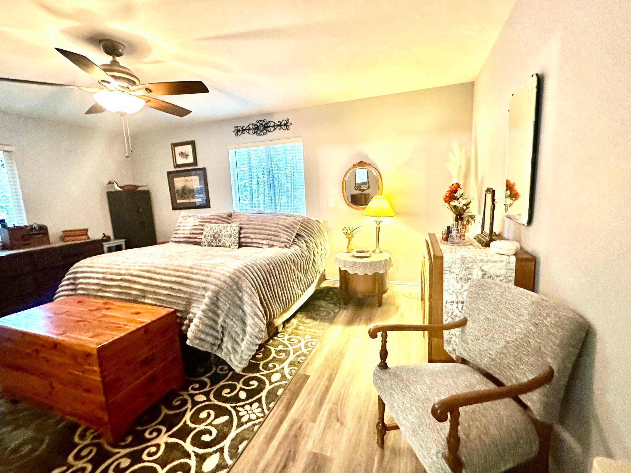 8308 Lost Mill Road Shingletown, CA 96088 - Photo 8 of 11 a bedroom with a bed and wooden floor