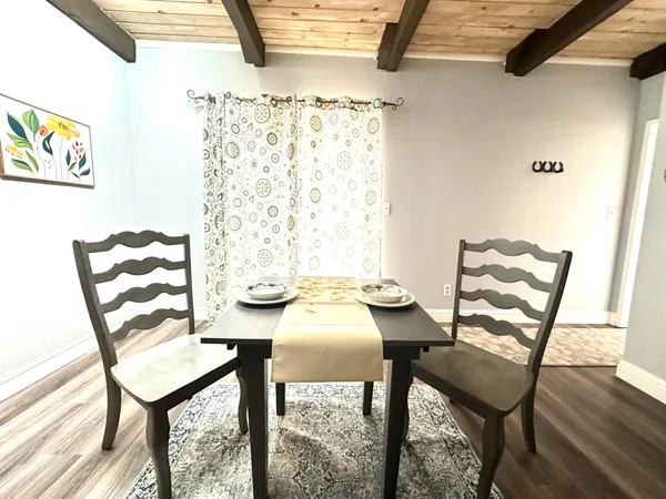 a view of a dining room with furniture and wooden floor
