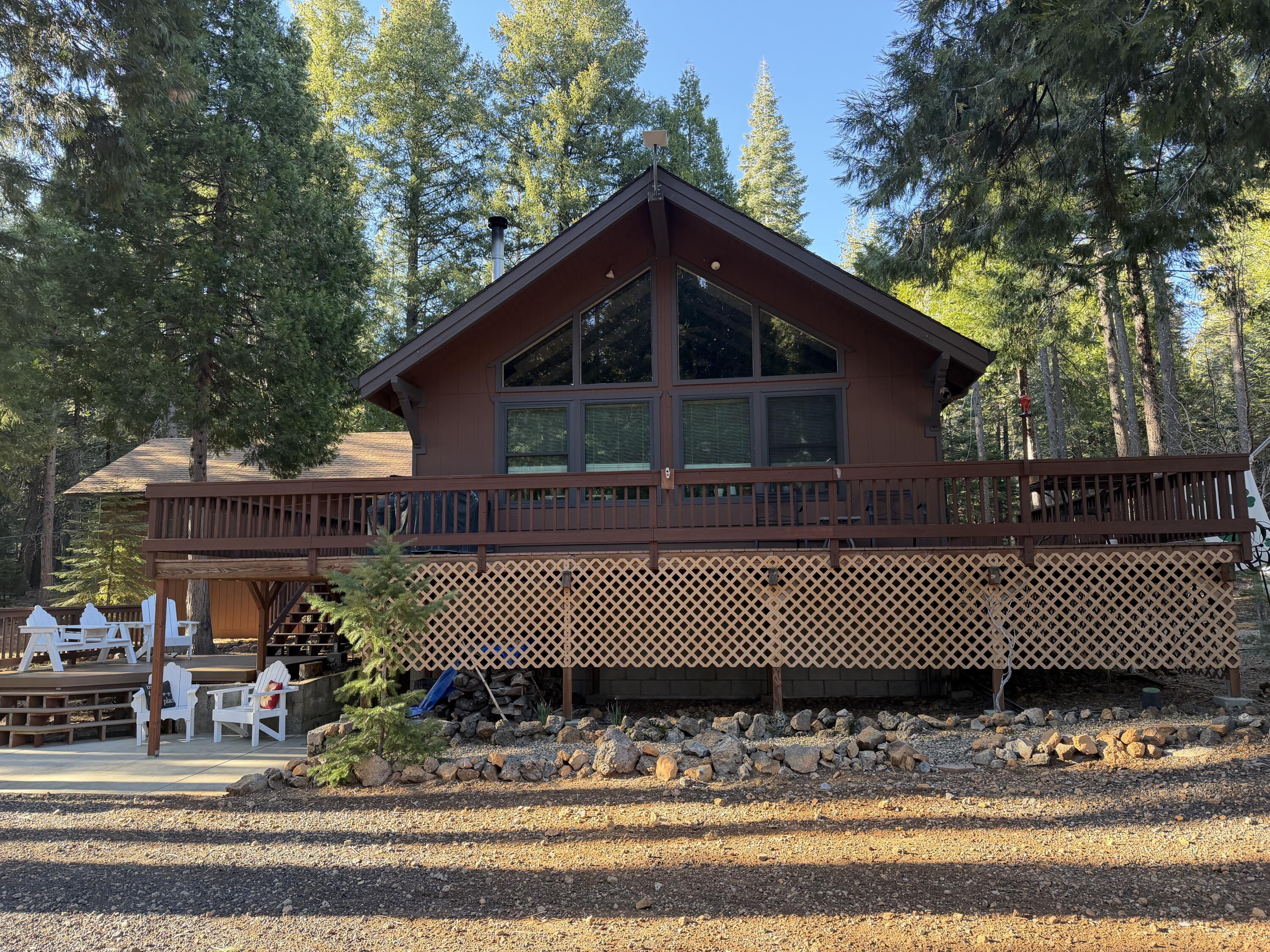 8308 Lost Mill Road Shingletown, CA 96088 - Photo 10 of 11 a front view of a house with a yard and trees