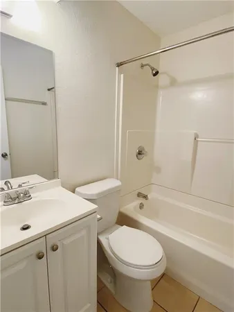 a bathroom with a sink toilet vanity and shower