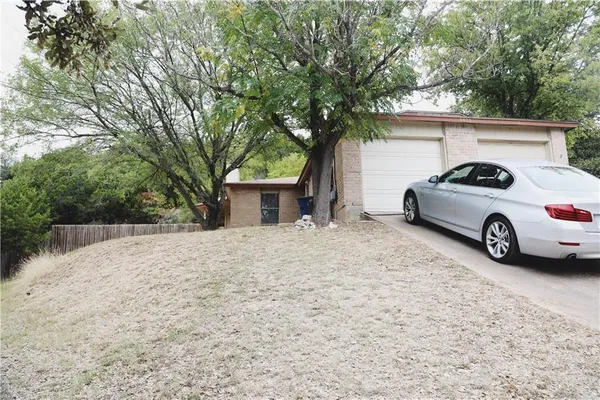 a car parked in front of white house