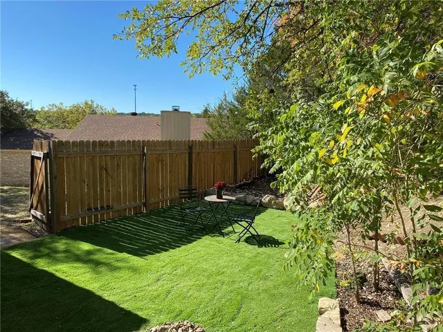 a view of a backyard with a tree