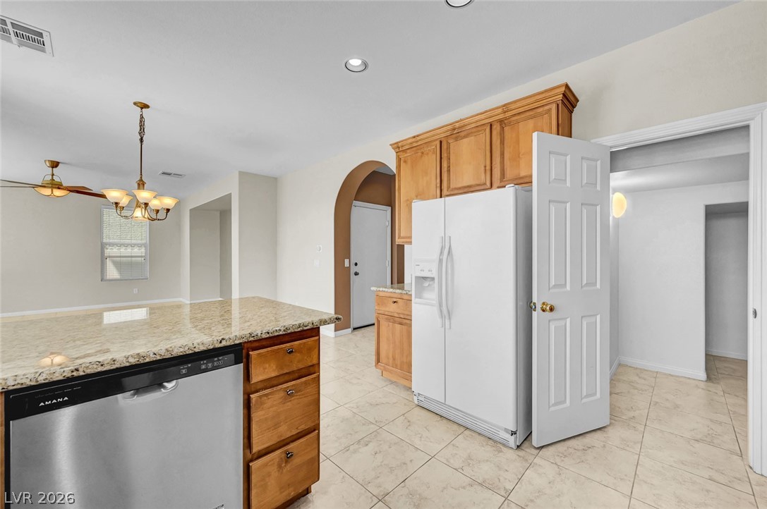 977 Sparkling Light Street Henderson, NV 89052 - Photo 34 of 75 This bright kitchen features ample counter space and connects seamlessly to living areas, ideal for gatherings.