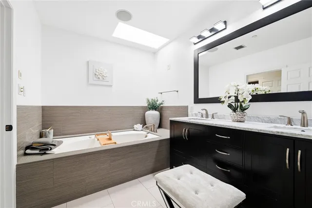 a bathroom with a sink double vanity and a shower