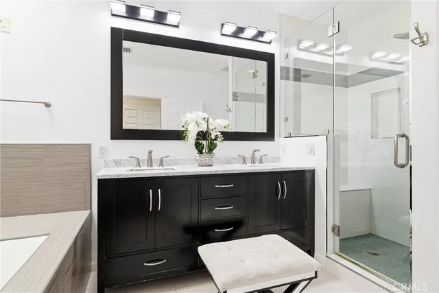 a bathroom with a granite countertop sink a toilet a shower and a mirror