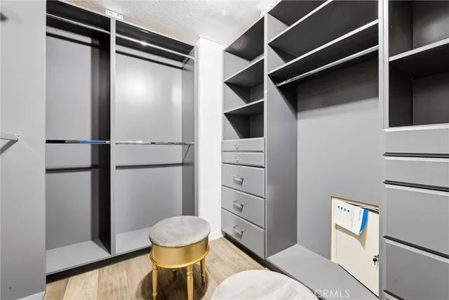 a utility room with wooden floor washer and dryer