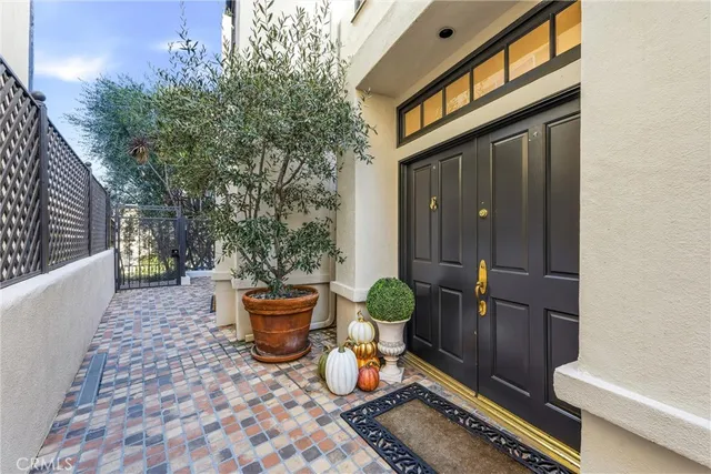 a bench and some potted plants in front of a door