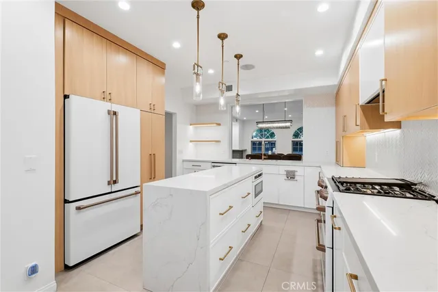 a kitchen with white cabinets and white appliances