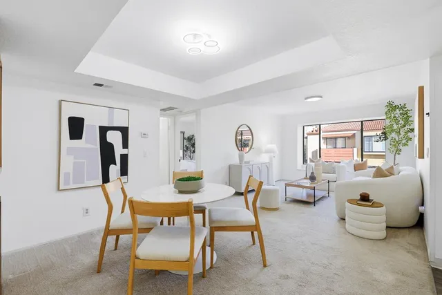 a dining room with furniture and window