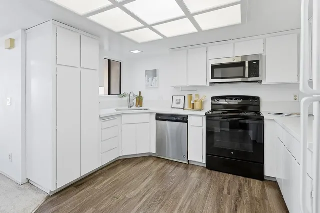 a kitchen with a sink stove and microwave