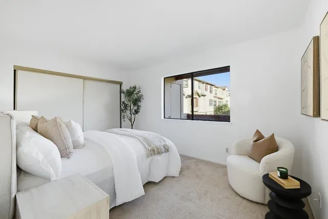 a bed room with a bed and a painting on the wall