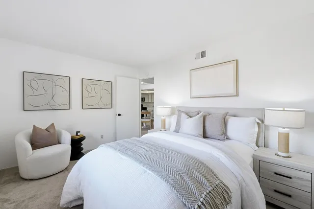 a bedroom with bed and furniture