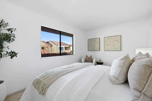 a bedroom with a bed and a painting on the wall