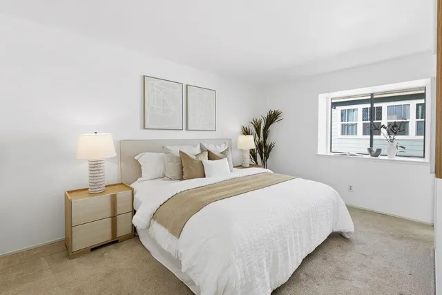 a bedroom with bed and window