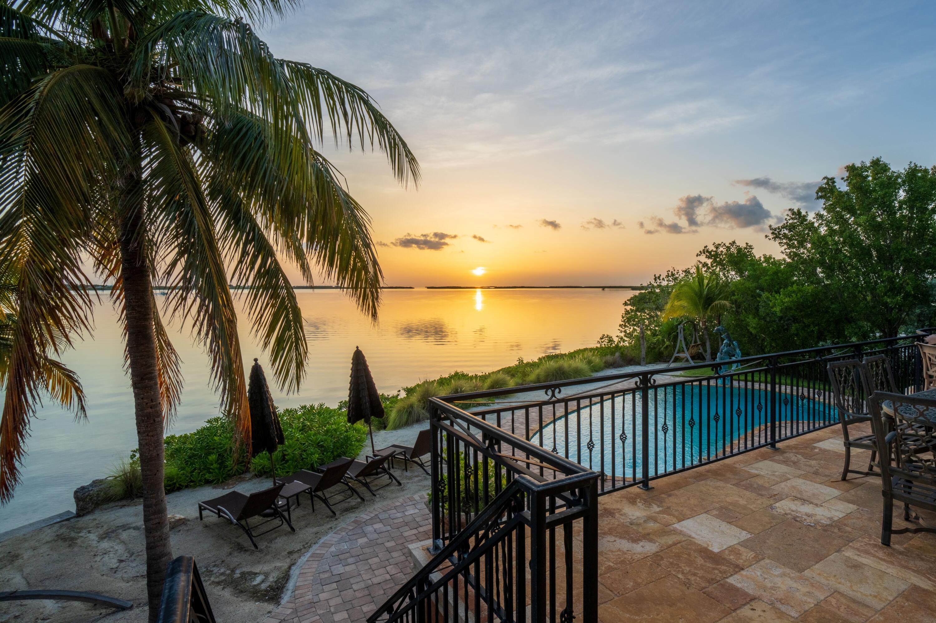30 Cannon Royal Drive Shark Key, FL 33040 - Photo 5 of 48 a view of balcony with wooden floor and outdoor seating