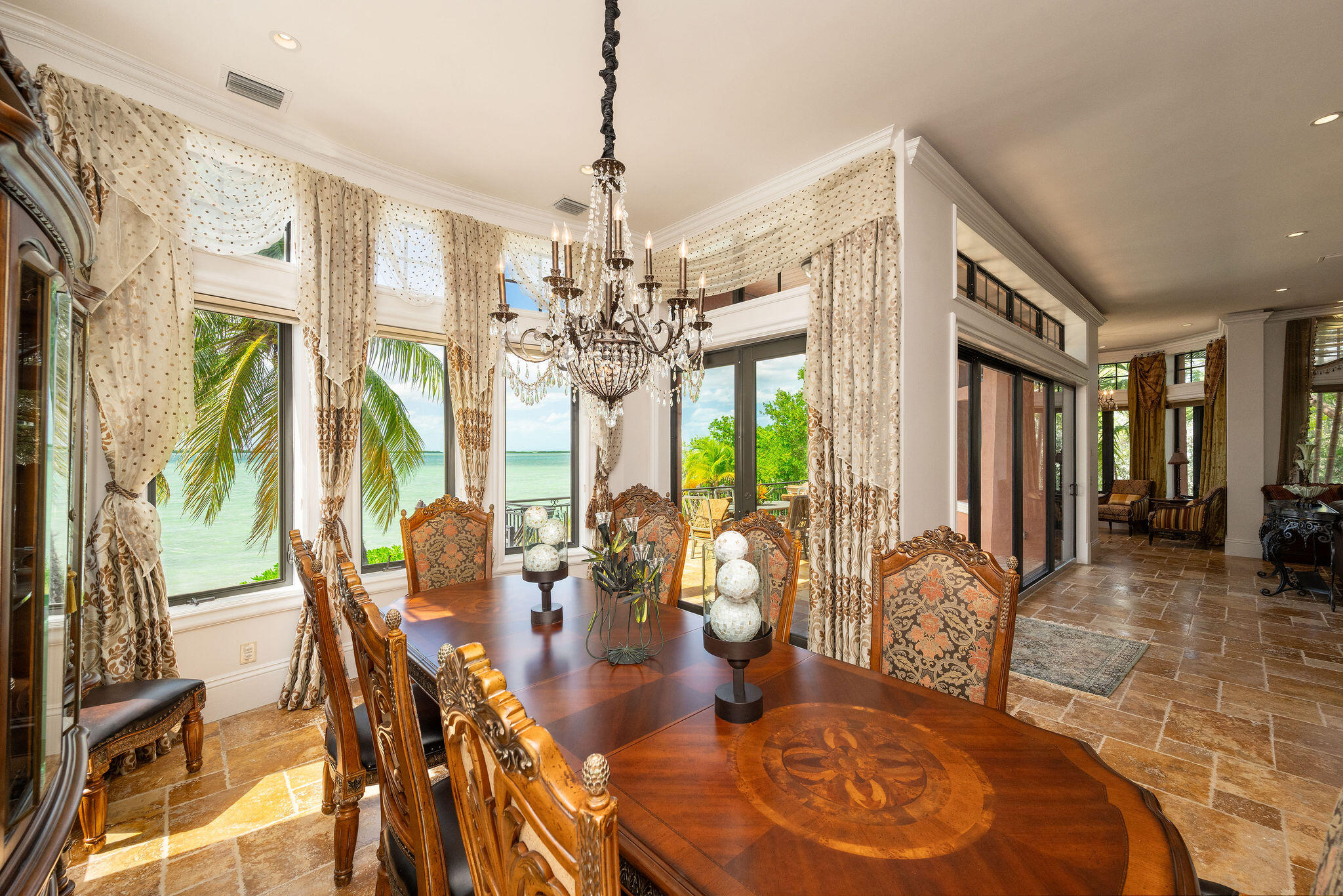 30 Cannon Royal Drive Shark Key, FL 33040 - Photo 7 of 48 a view of a dining room with furniture a chandelier and wooden floor