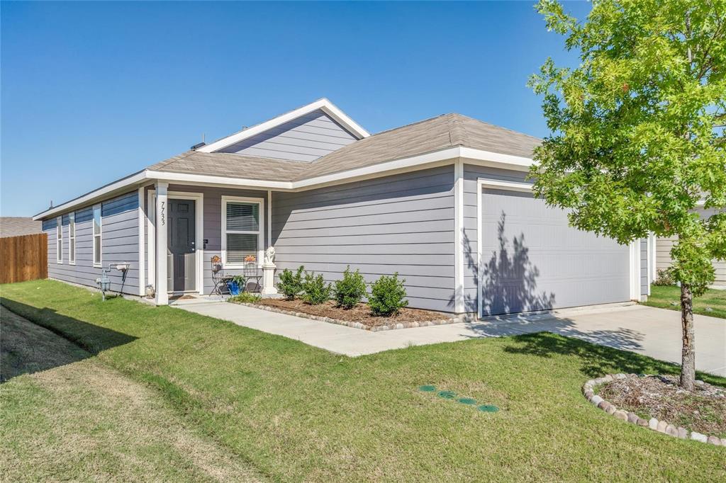View of front of home featuring a garage and concrete driveway