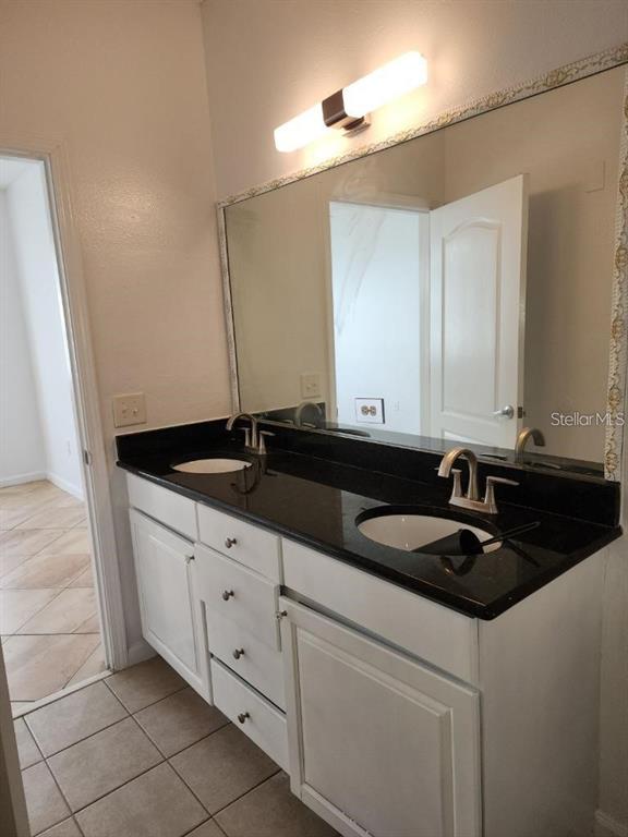 5255 Cane Island Loop, Unit 304 Kissimmee, FL 34746 - Photo 14 of 14 a bathroom with a sink and a mirror
