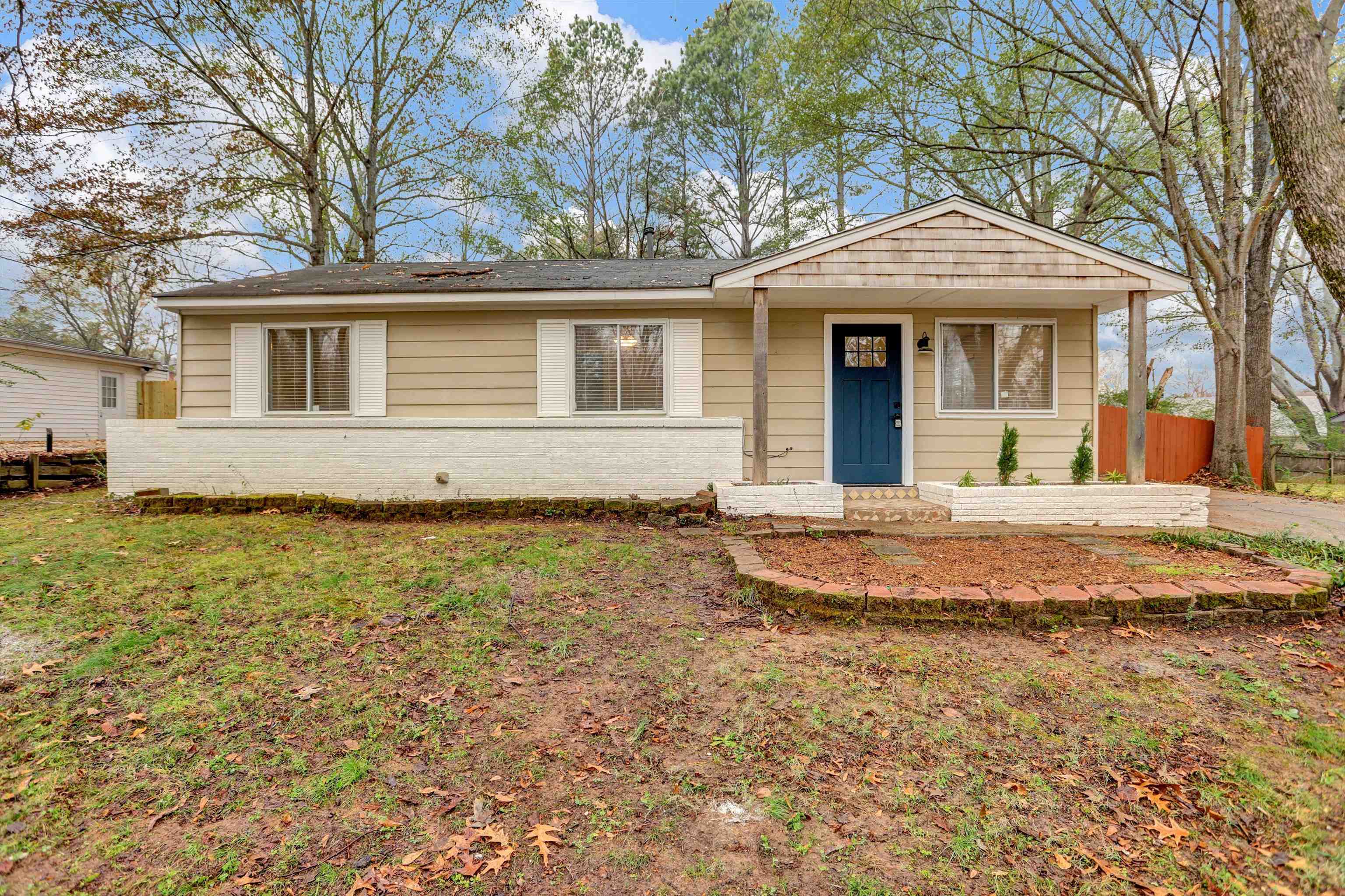 a front view of a house with a garden