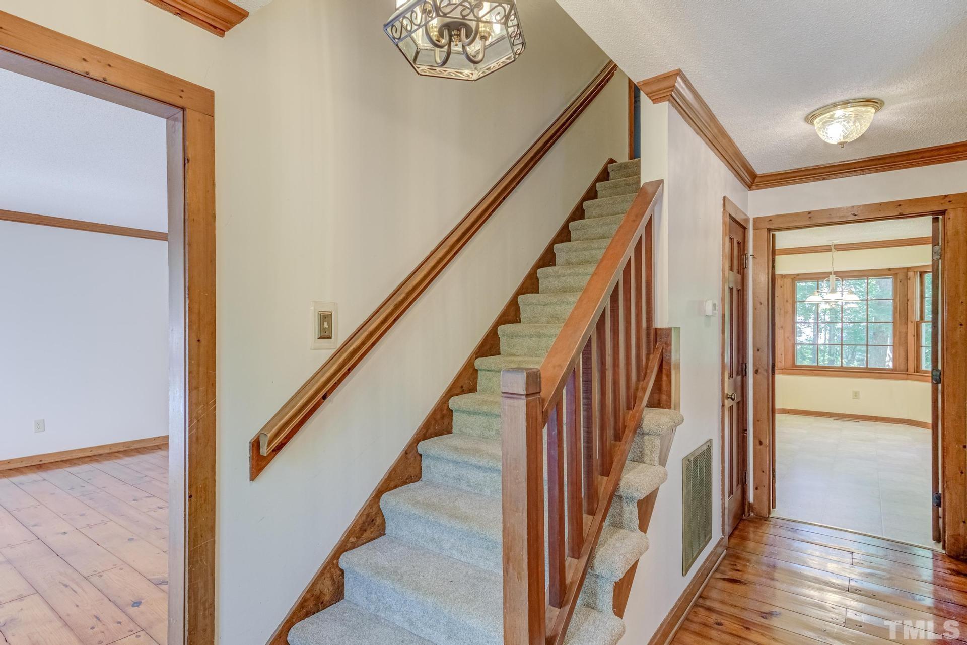 5904 Rondan Circle Raleigh, NC 27612 - Photo 8 of 44 a view of staircase with wooden floor and next to a window