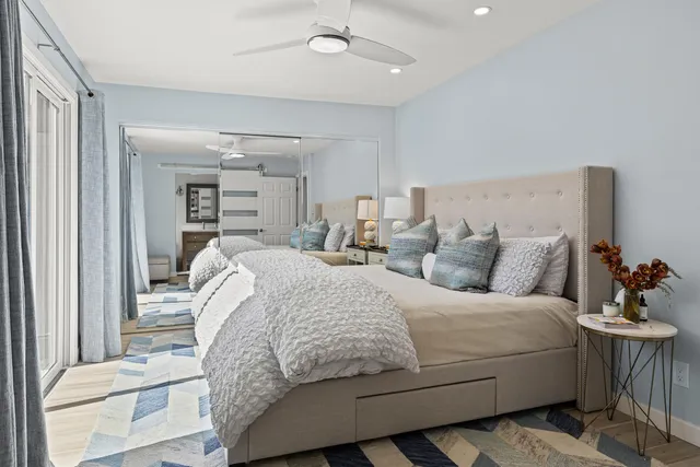 a bed room with a bed and a mirror