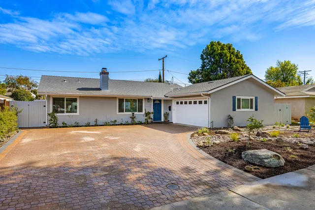 a view of a house with wooden fence