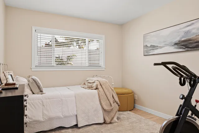 a bedroom with furniture and a potted plant