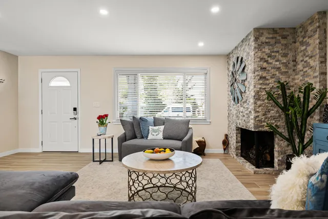 a living room with furniture and a fireplace