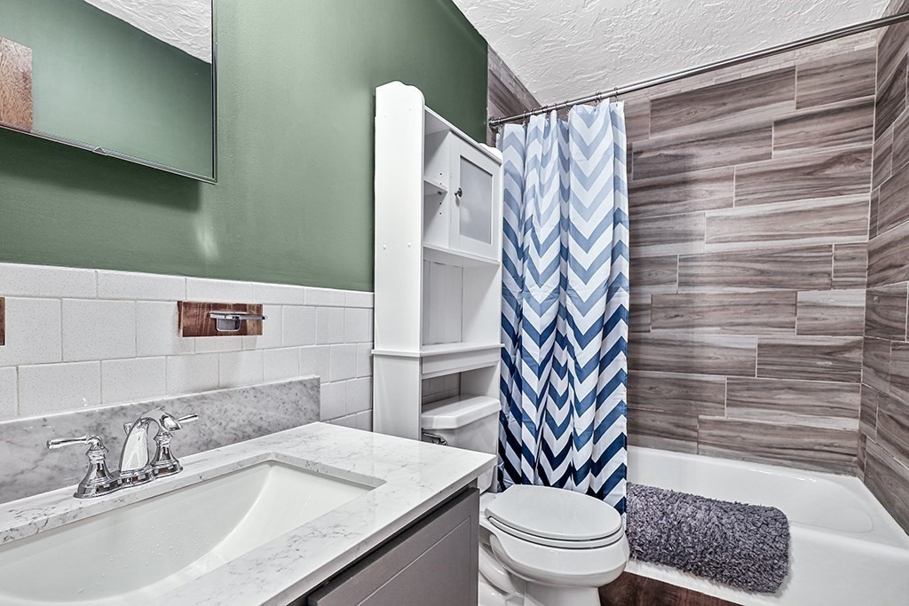 109 Maple Street, Unit E3 Attleboro, MA 02703 - Photo 14 of 18 a bathroom with a sink toilet and shower