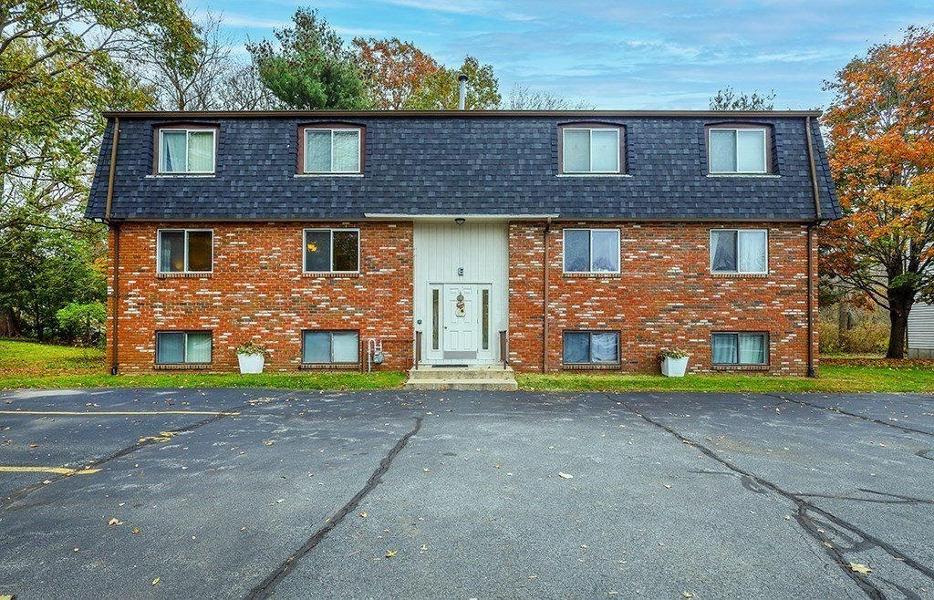 109 Maple Street, Unit E3 Attleboro, MA 02703 - Photo 2 of 18 a front view of a house with garden