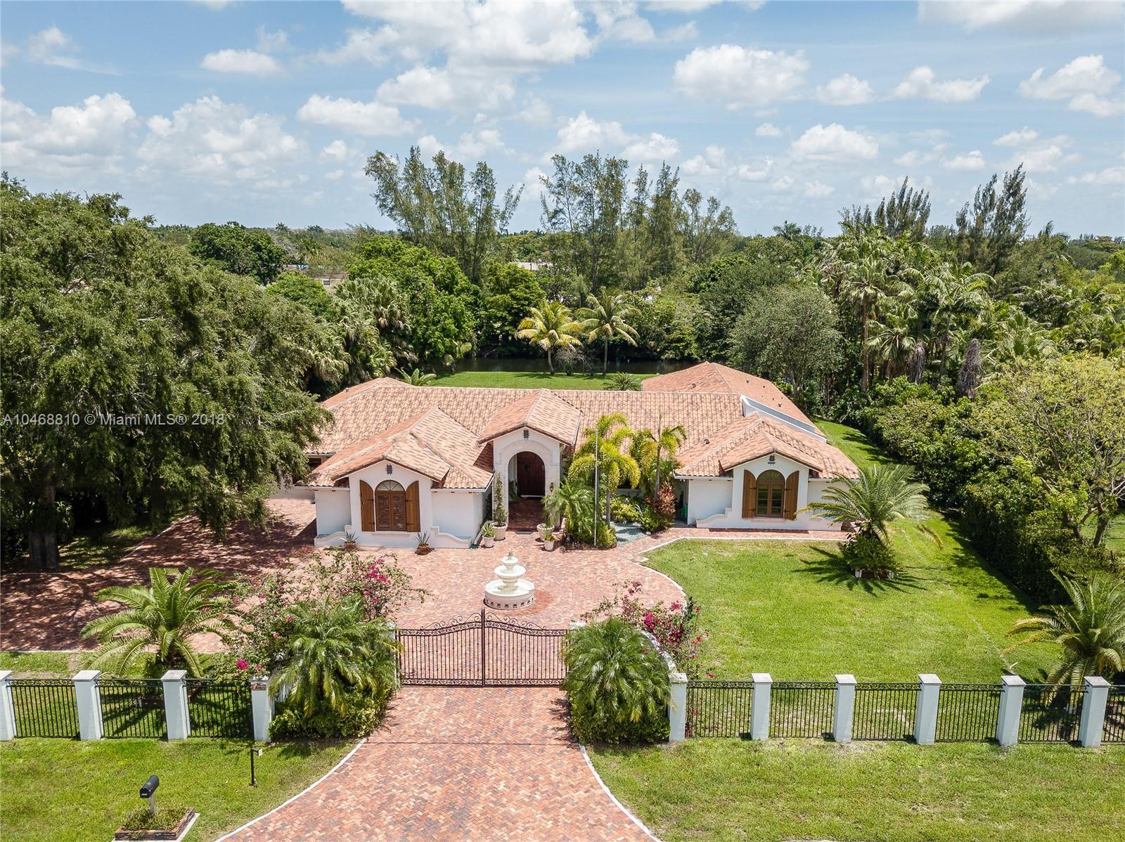 3451 Fox Trail Miramar, FL 33027 - Photo 1 of 33 a view of a white house with a big yard plants and large trees