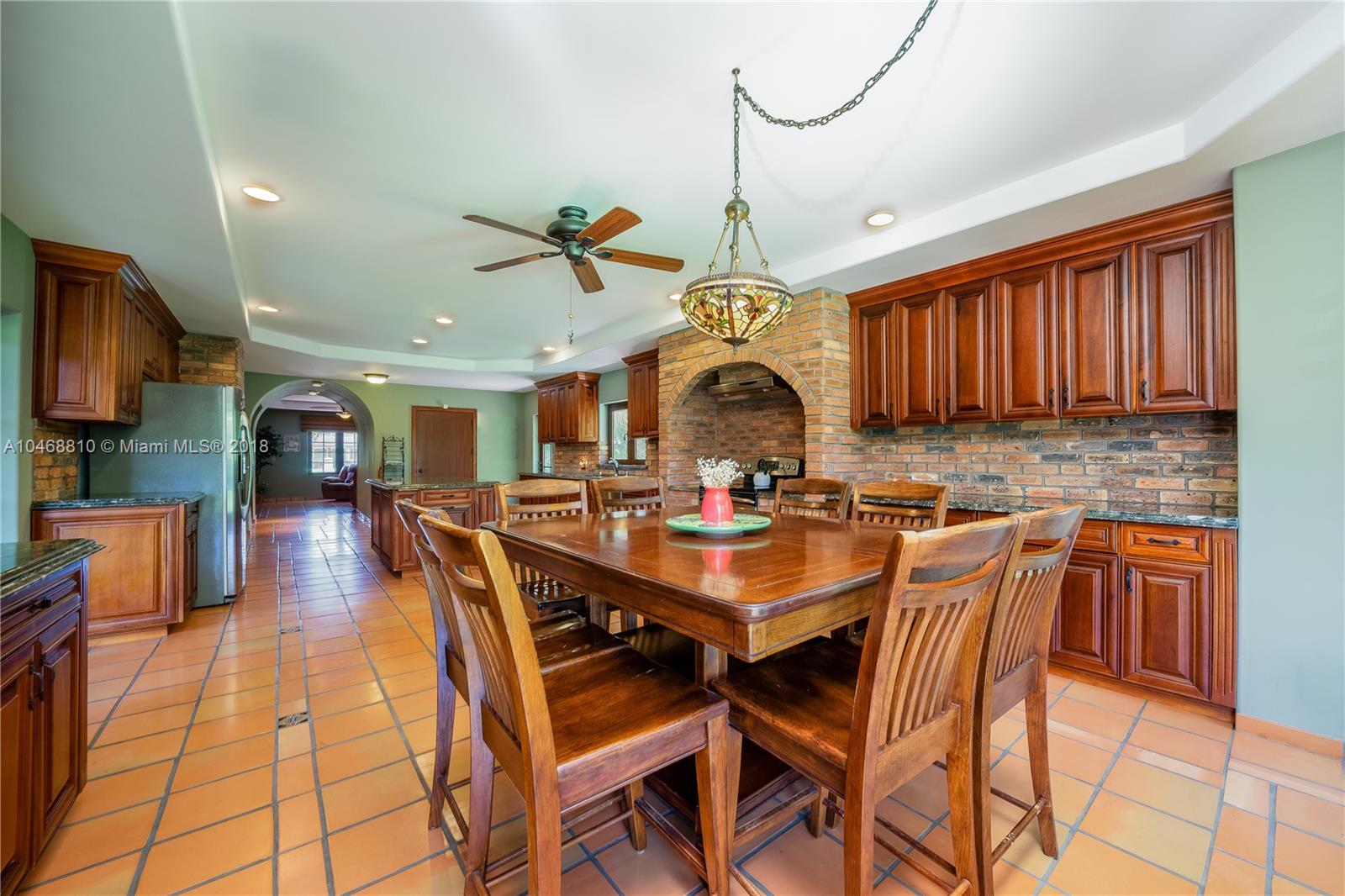 3451 Fox Trail Miramar, FL 33027 - Photo 15 of 33 a view of a dining room and livingroom with furniture wooden floor a rug a painting and a chandelier