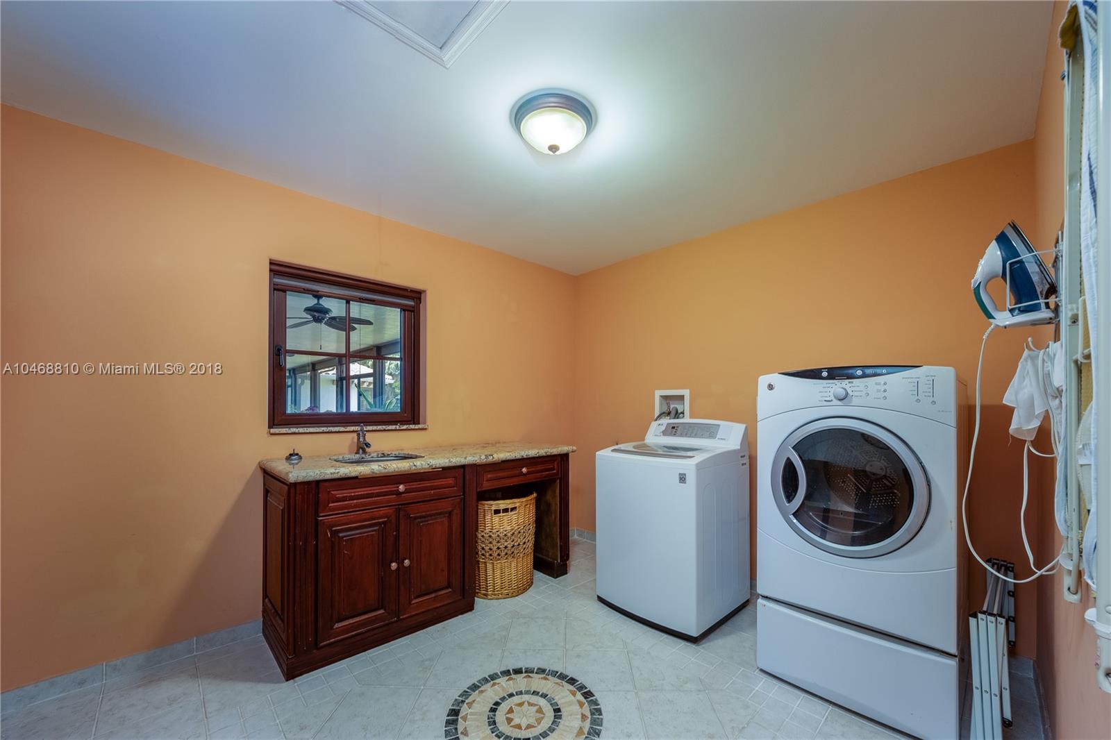 3451 Fox Trail Miramar, FL 33027 - Photo 18 of 33 a utility room with dryer washer and a view of living room