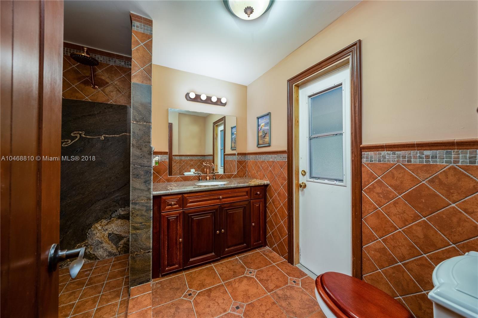 3451 Fox Trail Miramar, FL 33027 - Photo 29 of 33 a bathroom with a sink and a mirror