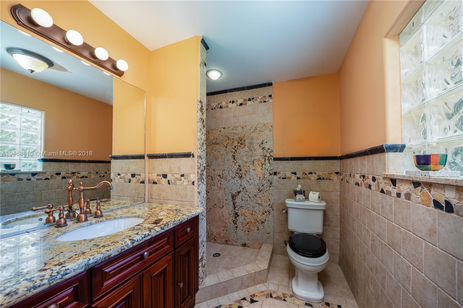 3451 Fox Trail Miramar, FL 33027 - Photo 32 of 33 a bathroom with a granite countertop toilet sink and mirror