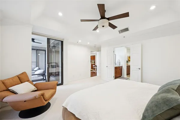 a bedroom with a bed and ceiling fan