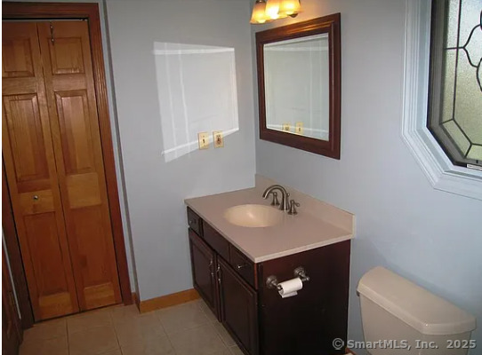 28 Lloyd Road Waterford, CT 06385 - Photo 12 of 16 a bathroom with a toilet sink and mirror