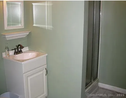 a view of a pathway with a wrought fence