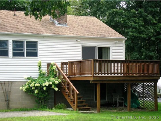 28 Lloyd Road Waterford, CT 06385 - Photo 2 of 16 a view of a house with brick walls and a yard with potted plants