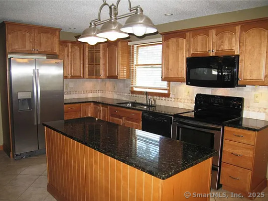 28 Lloyd Road Waterford, CT 06385 - Photo 5 of 16 a kitchen with granite countertop a sink stainless steel appliances and cabinets