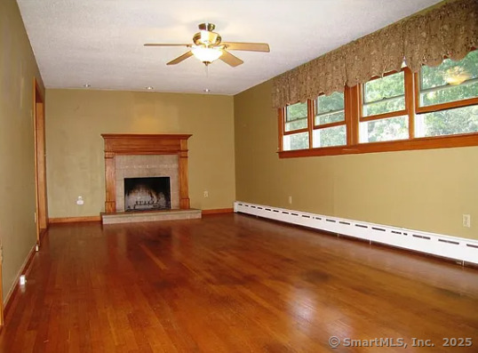 28 Lloyd Road Waterford, CT 06385 - Photo 9 of 16 a view of an empty room with a window and wooden floor