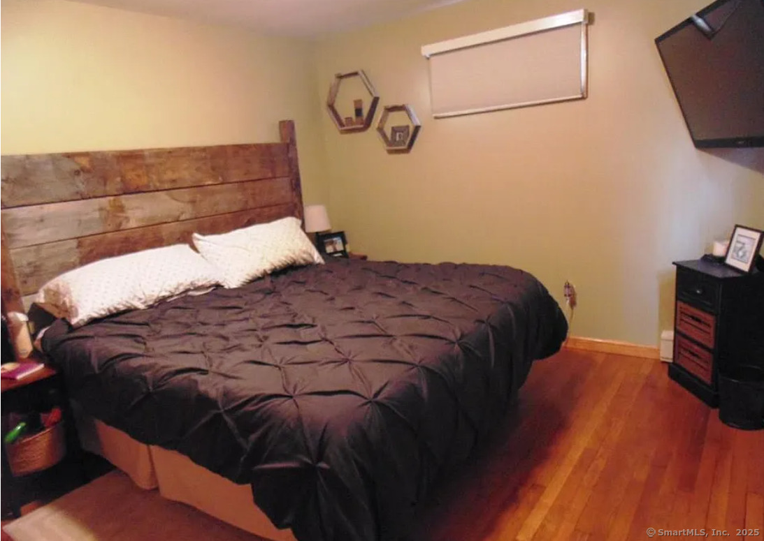 28 Lloyd Road Waterford, CT 06385 - Photo 10 of 16 a bedroom with a bed and a flat tv screen on the dresser