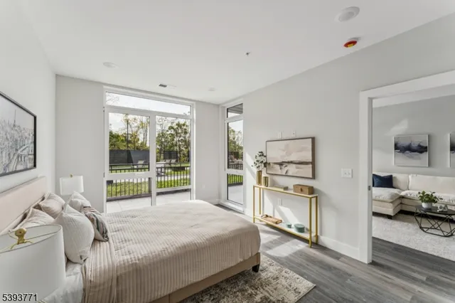 a bedroom with a bed and a large window with the outer view