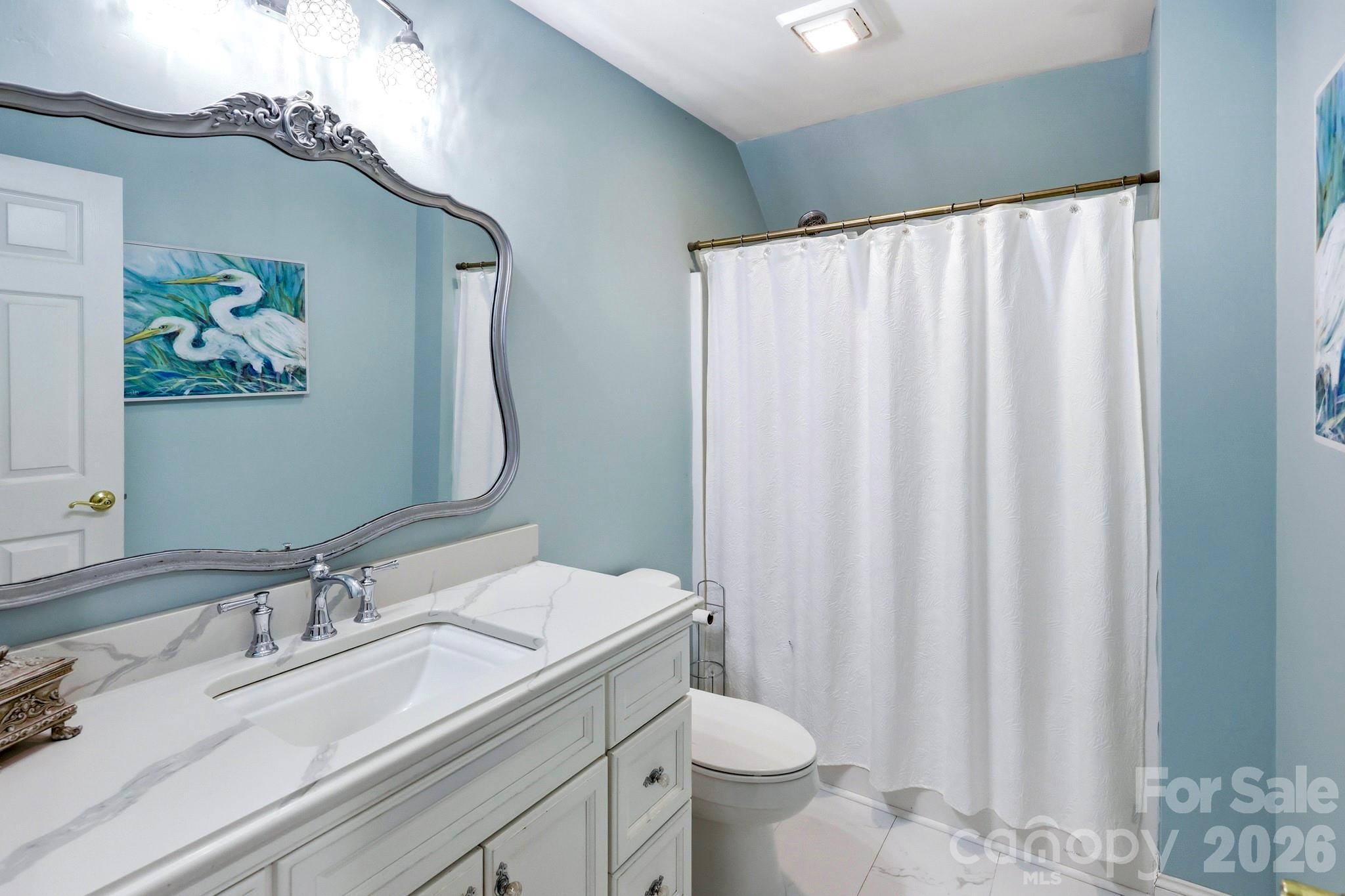 327 Sherry Street Rutherfordton, NC 28139 - Photo 16 of 22 a bathroom with a sink mirror vanity and toilet