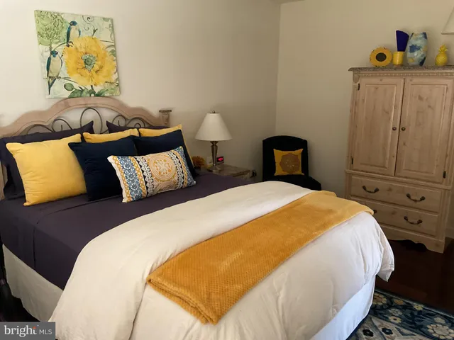 a bedroom with a bed and painting on the wall