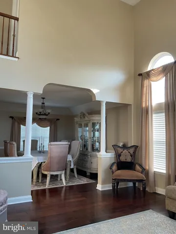 a living room with furniture wooden floor and a large window