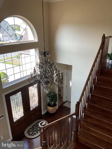 a view of staircase with furniture and a window