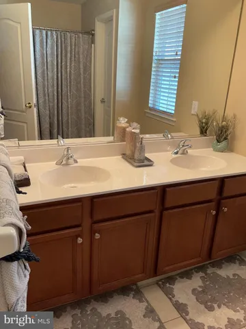 a bathroom with a sink vanity granite and a mirror
